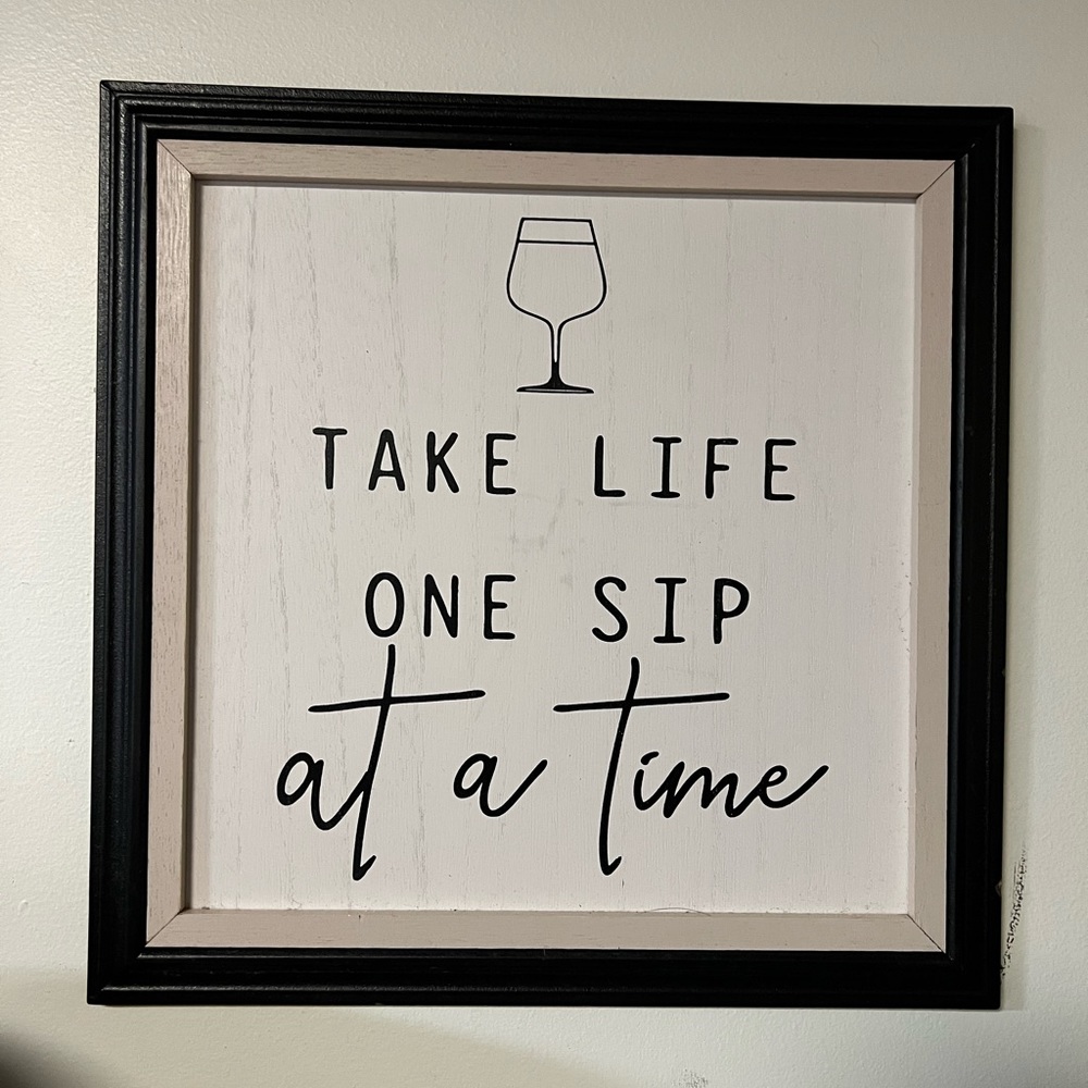 “Take life one sip at a time” bar sign